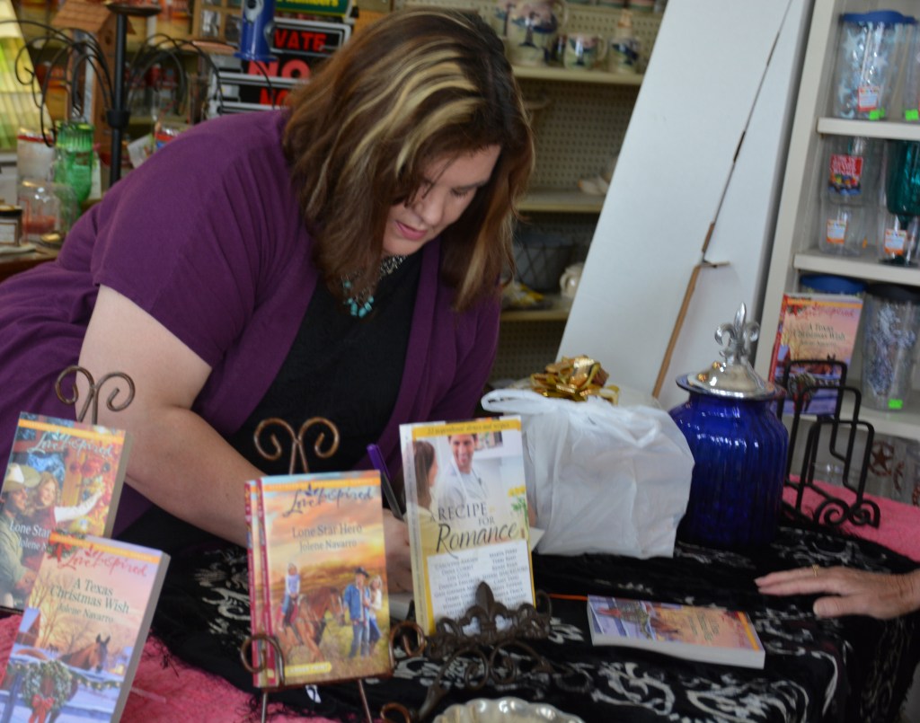 Jolene Navarro signing books at Bergmann Lumber
