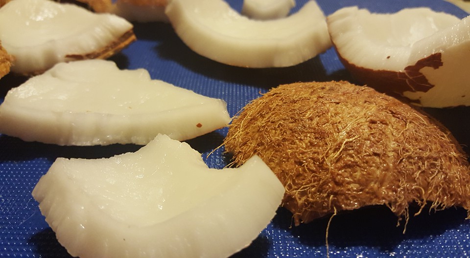 After draining the water, place the coconut in the oven at 350 for about 12 minutes. Then wrap it in a bag smash it with a hammer or throw it hard against a concrete floor. The harder the better.